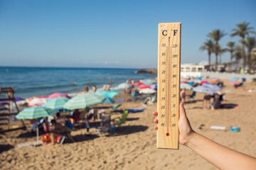 Hot weather. A temperature scale on a beach shows high temperatures during a heat wave.