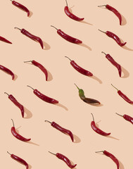 Pattern of green and red hot peppers on tan color background. Spicy food concept. .