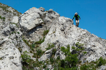 person climbing up the mountain