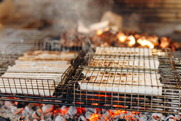 The chef is cooking pitas on fire.