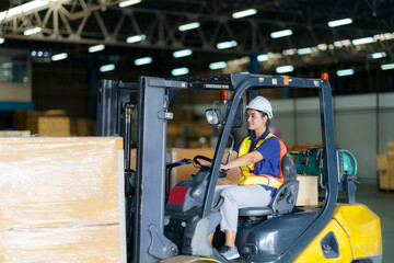 Asian beautiful woman driver drive fork lift car in industry with smile, ability of girl and...