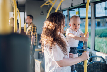 Mother and a baby riding in a bus in the city