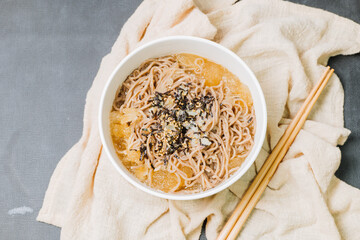 Korean food Naengmemilguksu, a winter delicacy, this buckwheat noodle dish is served in a cold chicken- or beef-based broth and topped with cold slices of beef and egg as a garnish.