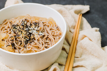 Korean food Naengmemilguksu, a winter delicacy, this buckwheat noodle dish is served in a cold chicken- or beef-based broth and topped with cold slices of beef and egg as a garnish.