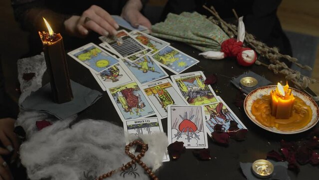 4K. A witch woman in a dark room reading tarot cards