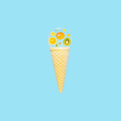 Ice cream cone with slices of fresh tropical fruits, reflected in a glass sphere on bright blue background. Summer vibes, tropical fruit composition.
