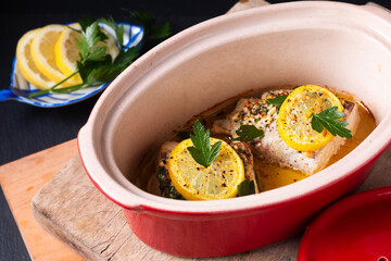 Healthy Food concept Homemade Lemon garlic butter Baked Cod fish on black background with copy space
