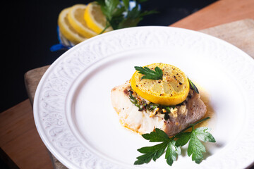 Healthy Food concept Homemade Lemon garlic butter Baked Cod fish on black background with copy space