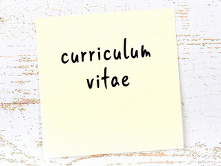 Yellow sheet of paper with word curriculum vitae. Reminder concept
