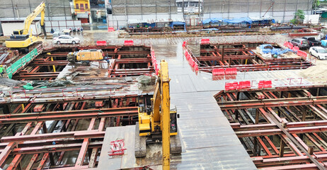 Building construction site in the city. Underground foundation for high-rise building. Metal structure and iron beam for building construction.