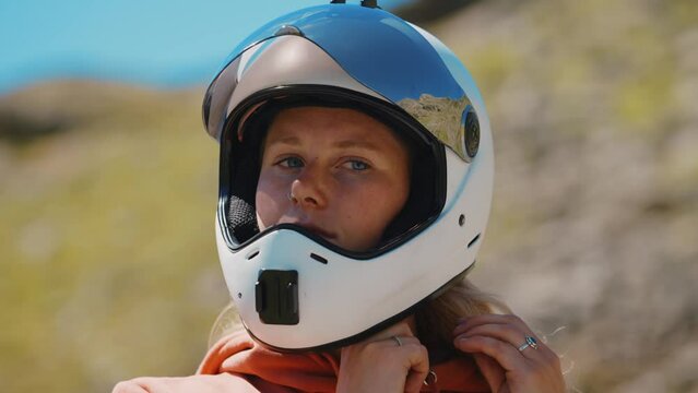 Cinematic downhill longboard session. Young woman skateboarding and making tricks between the curves on a mountain pass. Concept about extreme sports and people
