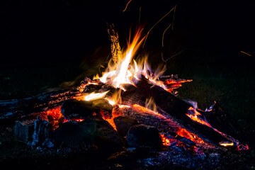 Campfire at night. Flames and embers of a bonfire at night.