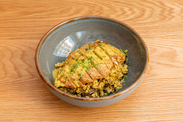 A sliced fried chicken fillet with rice and Moorish-style sauce