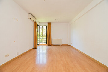 Fototapeta na wymiar Living room with wooden floors, air conditioner and bay window in one corner