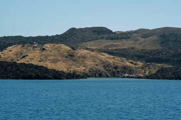 Close up view of the island of volcanic origin, Nea Kameni, that has been formed over repeated eruptions of dacite lava and ash in Santorini  