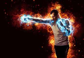 Boxing and fitness concept. Boxer man fighting or posing in gloves on black background with fire. Individual sports recreation. Energy and power