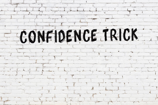 Night View Of Neon Sign On Brick Wall With Inscription Confidence Trick