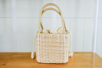 A handmade straw bag on the shelf.