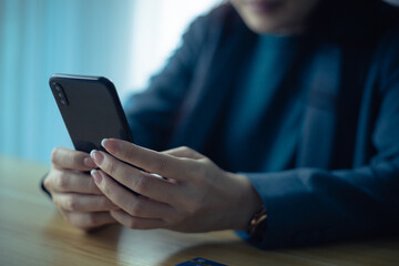 Hand holding credit card and using computer. Shopping online, e-commerce, internet banking, working from home concept.