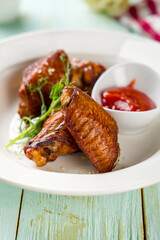 Buffalo chicken wings with ketchup on white plate