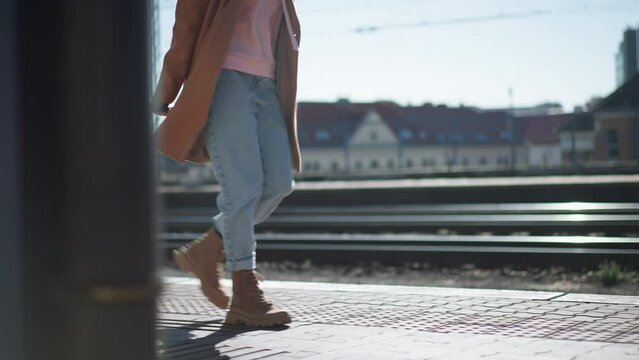 Woman traveler tourist waiting with luggage at train station, cut out.