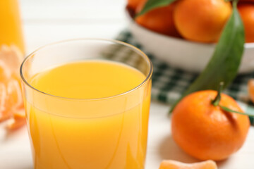 Glass of fresh tangerine juice, closeup view