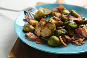 Roasted brussels sprouts with bacon on plate, closeup