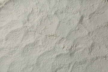 Fototapeta na wymiar Pile of organic flour as background, top view