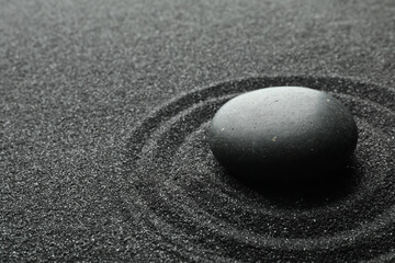 Fototapeta na wymiar Black sand with stone and beautiful pattern. Zen concept