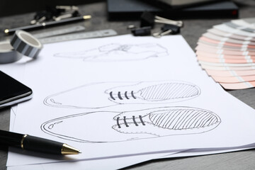 Drawing of shoes on table, closeup. Designer's workplace