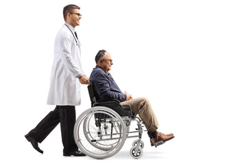 Full length profile shot of a doctor walking and pushing a mature man in a wheelchair