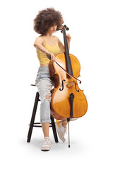 Young female musician sitting on a chair and playing a contrabass © Ljupco Smokovski