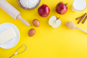 Top view of ingredients for making apple pie or cake on the yellow  background. Copy space.