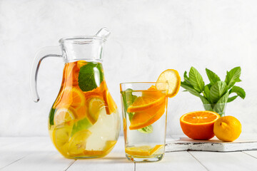 Citrus drink with lemon, orange and mint. Healthy and healthy drink in a transparent glass with copy space
