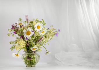 A bouquet of wildflowers on a light background. Copy space for text