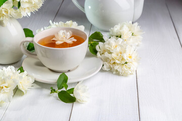 Jasmine tea in a cup on a wooden background. Copy space