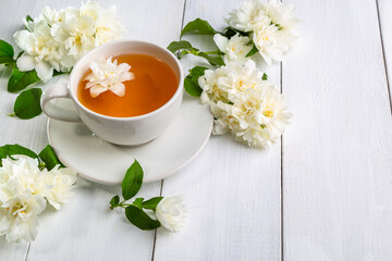 Jasmine tea in a cup on a wooden background. Copy space