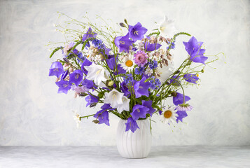 Bouquet of wild flowers on a light background