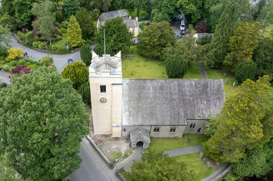 Bird's eye view of the St. Oswald's Church, Grasmere surrounded by green trees in England