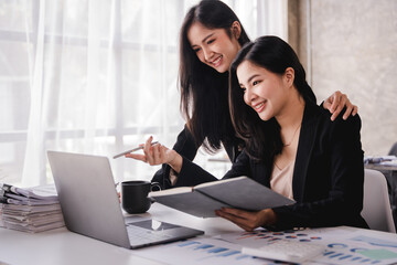 Team of Asian businessmen working in the office with documents on their desks. Planning to analyze financial reports business plan investment financial analysis concept