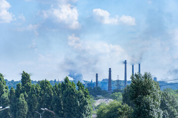 View of industrial plant for the production of metal smelting. Metallurgical plant to the city. Steelmill. Blast furnaces on large integrated steelworks.The problem of ecology in a big city. Smoke.