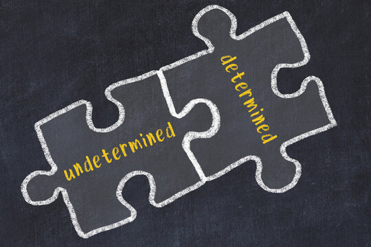 Chalk drawing of two puzzles with words undetermined and determined