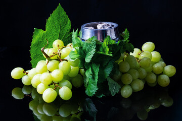 Creative photo of tobacco for hookah with grape flavor, grape hookah, bowl with coals and tobacco...