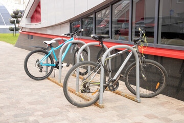 Fototapeta na wymiar two bikes parked in a street bike rack