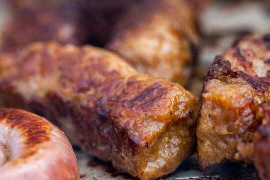 Closeup of delicious traditional Romanian grilled Mici pork meat rolls