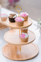 many cup cake on wood shelf in wedding ceremony and birthday party.concept for food and desert in party