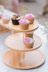 many cup cake on wood shelf in wedding ceremony and birthday party.concept for food and desert in party