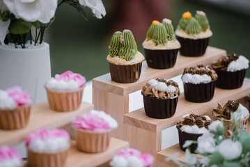 many cup cake on wood shelf in wedding ceremony and birthday party.concept for food and desert in party