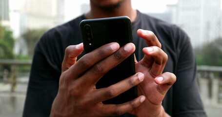 African black man using cellphone in street