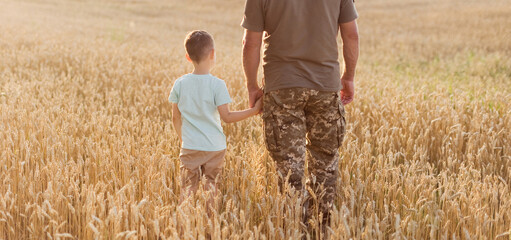 Military man and child holding hands